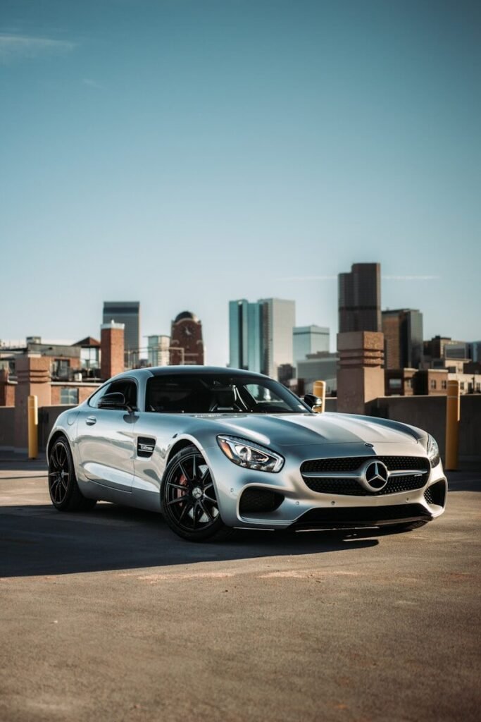 silver mercedes benz coupe parked on gray concrete road during daytime